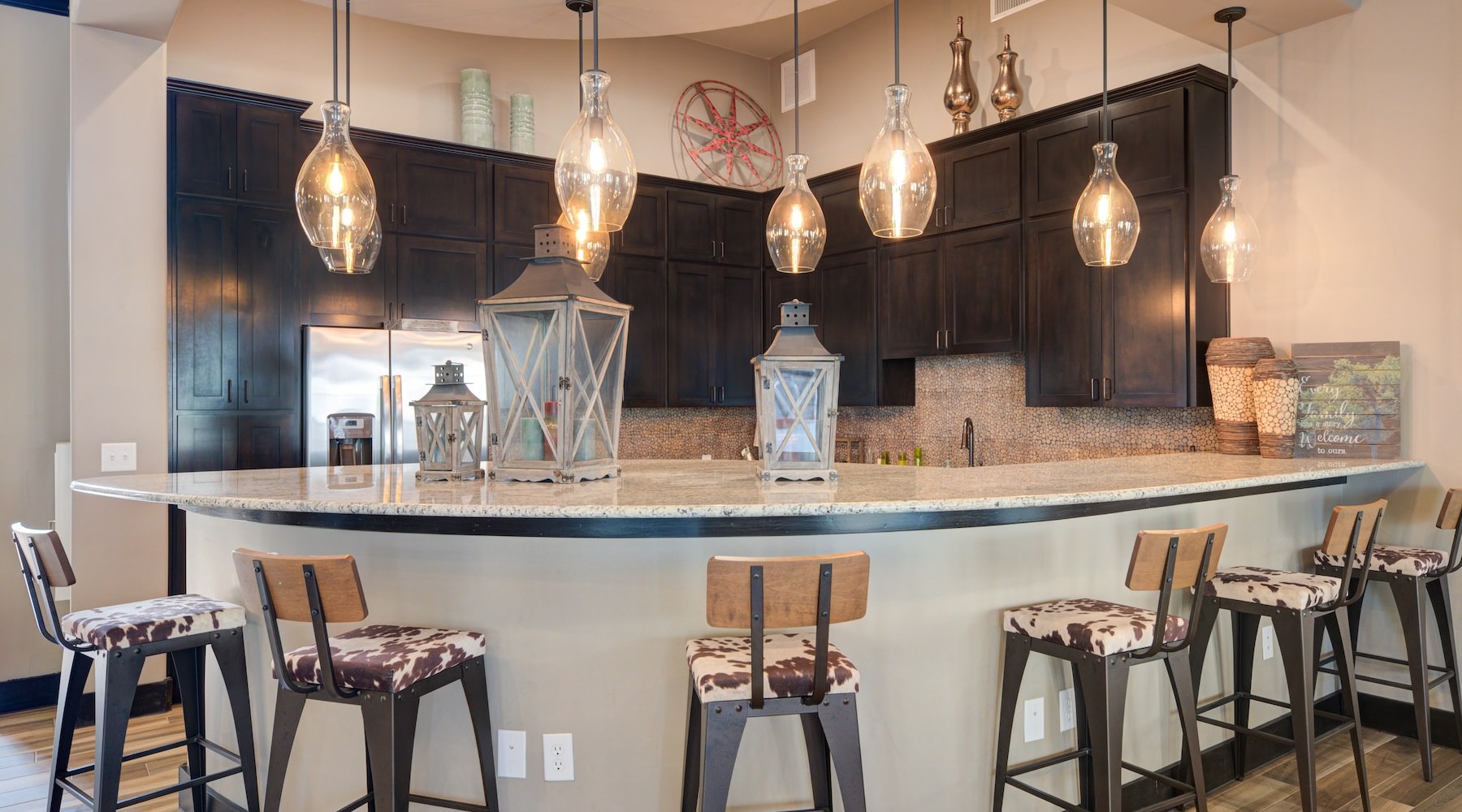 a community kitchen with a bar and chairs