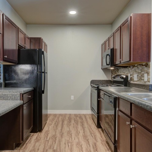 a kitchen with wooden cabinets