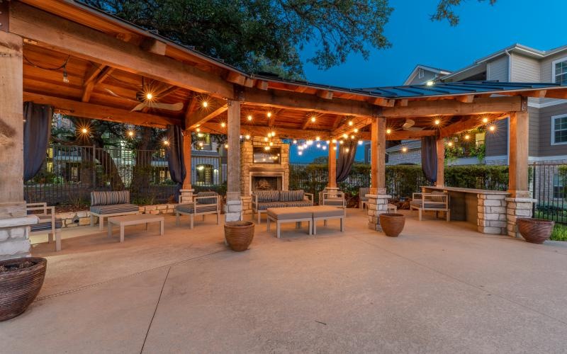 a covered patio with benches and a covered area