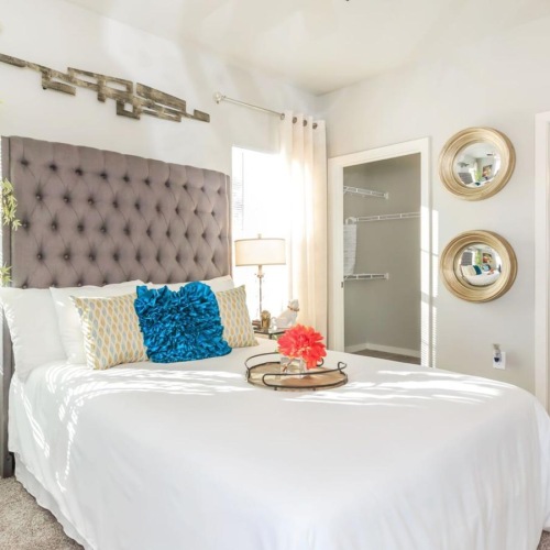 a bedroom with a bed and a chair