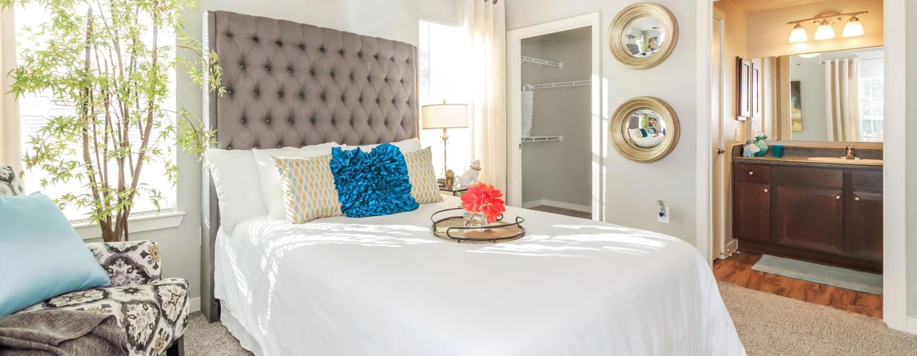 a bedroom with a bed and a chair